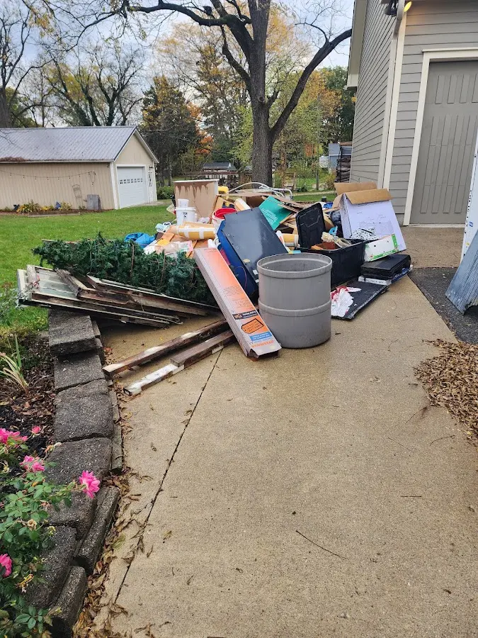Dumpster being loaded with debris for Estate Cleanout Dumpster Rental in Ovilla